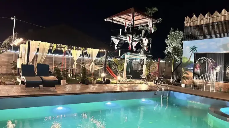 The pool, machan and dining area lit at night